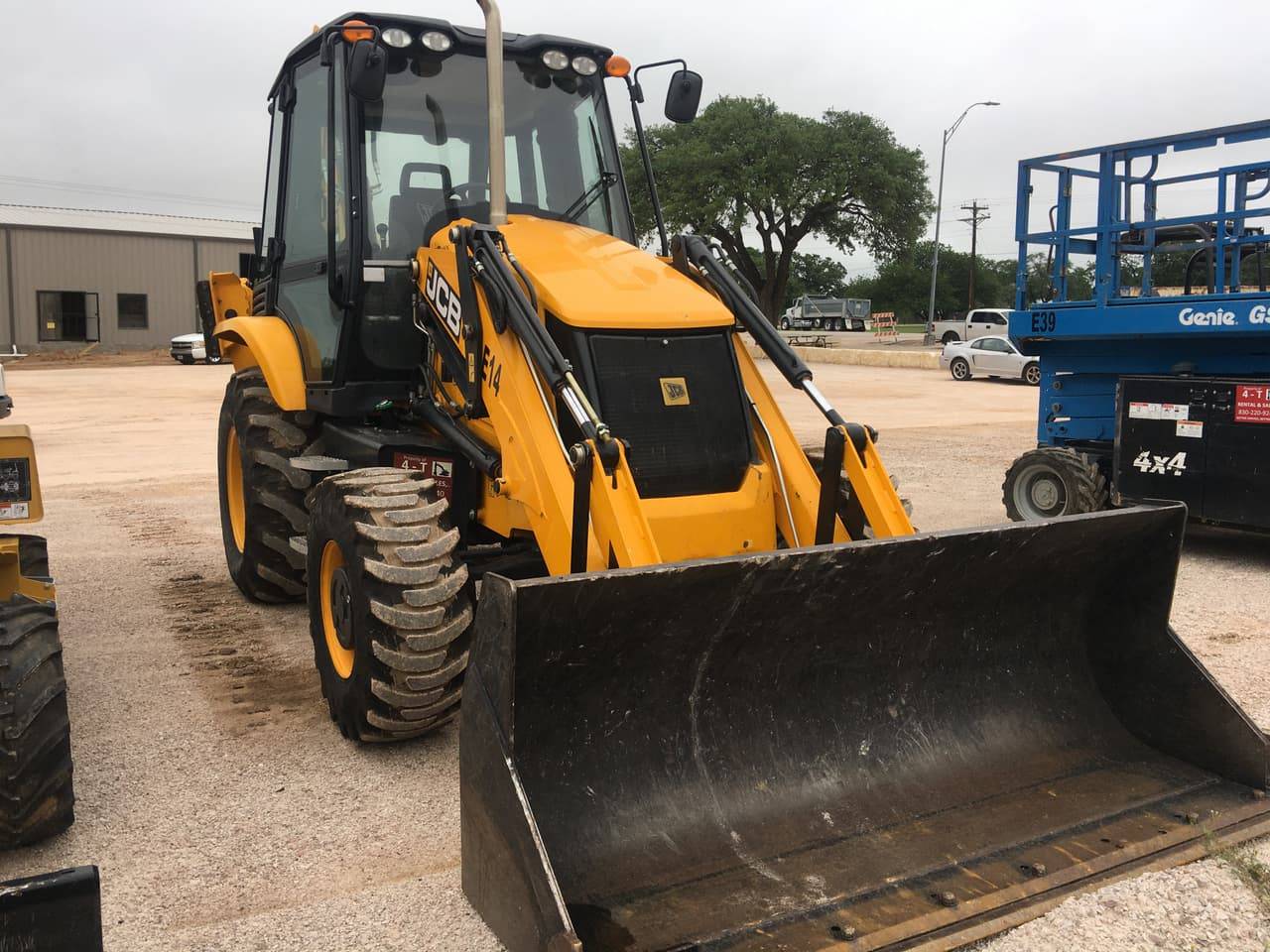 JCB backhoe loader with front bucket on the 4-T Rental & Sales yard